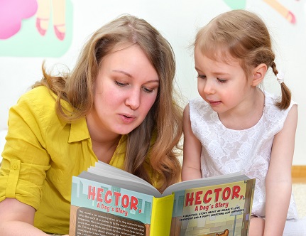 Young woman and little girl read a book